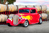 AUT 26 RK3240 01
1934 Chevrolet 3-Window Coupe Red With Flames 3/4 Front View On Gravel By Barrels