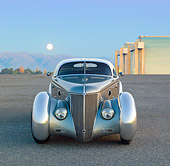 AUT 26 RK3296 01
1936 Ford AeroSport Silver Front View On Pavement By Hangars At Dusk