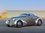 AUT 26 RK3297 01
1936 Ford AeroSport Silver 3/4 Side View On Pavement By Hangars At Dusk