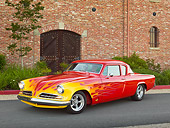AUT 26 RK3324 01
1954 Studebaker Champion Coupe Hot Rod Red With Flames 3/4 Front View On Pavement By Brick Building