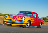 AUT 26 RK3325 01
1954 Studebaker Champion Coupe Hot Rod Red With Flames 3/4 Front View On Road By Vineyard