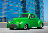 AUT 26 RK3355 01
1941 Willys Coupe Hot Rod Synergin Green 3/4 Front View On Concrete By Glass Building