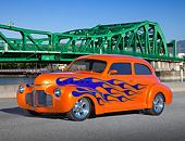 AUT 26 RK3357 01
1941 Chevrolet 2-Door Sedan Orange With Blue Flames 3/4 Front View On Pavement By Bridge