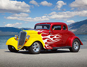 AUT 26 RK3365 01
1934 Ford 5 Window Coupe Red With Flames 3/4 Side View On Pavement By Lake