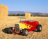 AUT 26 RK0039 04
1932 Ford Hi-Boy Roadster Red And Yellow 3/4 Front View By Hay Bales