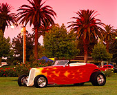 AUT 26 RK0090 05
1933 Ford Hi Boy Convertible Red With Flames 3/4 Front View On Grass By Trees Filtered