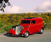 AUT 26 RK0177 02
1933 Ford Sedan Delivery Red 3/4 Front View On Pavement  By Shrubs Filtered