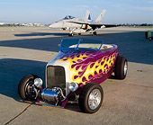 AUT 26 RK0223 02
1932 Ford Hi-Boy Roadster Purple With Flames 3/4 Front View On Pavement By Fighter Jet