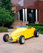 AUT 26 RK0256 02
1929 Ford Highboy Yellow 3/4 Front View On Pavement By Trees And Bushes