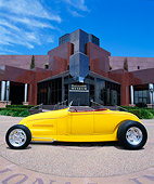AUT 26 RK0259 01
1929 Ford Highboy Yellow Low Profile On Pavement By Museum Blue Sky