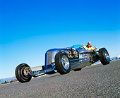AUT 26 RK0306 02
Blastolene Special Concept Race Car With Driver Low Slanted 3/4 Front View On Pavement Blue Sky