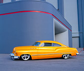 AUT 26 RK0357 01
1950 Buick Sedanette Tangerine 3/4 Side View On Pavement By Building