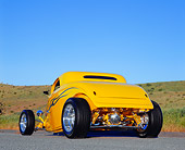 AUT 26 RK0378 02
2004 Speed Star Coupe Yellow Blue Flames 3/4 Rear View On Pavement By Grass Hill