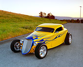 AUT 26 RK0381 01
2004 Speed Star Coupe Yellow Blue Flames 3/4 Front View On Pavement By Grass Hill Filtered