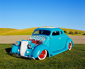 AUT 26 RK0389 05
1936 Ford Custom Coupe Light Blue 3/4 Front View On Grass Blue Sky
