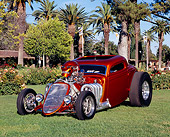 AUT 26 RK0454 01
1933 Ford 3 Window Coupe Candy Orange 3/4 Front View On Grass By Trees