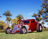 AUT 26 RK0456 01
1933 Ford 3 Window Coupe Candy Orange Low 3/4 Front View On Grass By Trees