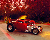 AUT 26 RK0462 01
1933 Ford 3-Window Coupe Candy Orange 3/4 Front View On Pavement By Trees At Dusk