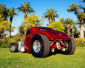 AUT 26 RK0464 02
1933 Ford 3-Window Coupe Candy Orange Low 3/4 Rear View On Grass By Trees