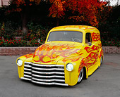 AUT 26 RK0501 03
1950 Chevy Panel Yellow With Flames 3/4 Front View On Pavement By Fall Trees