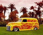 AUT 26 RK0503 01
1950 Chevy Panel Yellow With Flames 3/4 Side View On Grass By Palm Trees