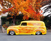 AUT 26 RK0504 04
1950 Chevy Panel Yellow With Flames Side View On Pavement By Fall Trees