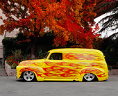 AUT 26 RK0504 05
1950 Chevy Panel Yellow With Flames Side View On Pavement By Fall Trees
