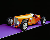 AUT 26 RK0522 05
2005 Zane Speedster Orange Side 3/4 View On Purple Floor Studio