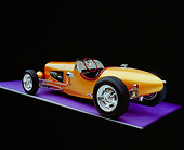 AUT 26 RK0527 01
2005 Zane Speedster Orange Rear 3/4 View On Purple Floor Gray Line Studio