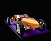AUT 26 RK0528 03
2005 Zane Speedster Orange Rear 3/4 View On Purple Floor Gray Line Studio