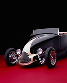 AUT 26 RK0539 09
1929 Ford Track Nose Roadster Black And Cream Front 3/4 View On Red Floor Studio