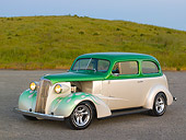 AUT 26 RK0670 01
1937 Chevrolet Sedan Green And White 3/4 Side View On Pavement By Grass Hill