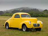 AUT 26 RK1154 01
1940 Willys 440 Coupe Yellow 3/4 Front View On Grass