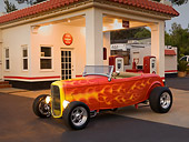 AUT 26 RK1170 01
1932 Ford Roadster Orange Pearl 3/4 Side View On Pavement By Gas Station