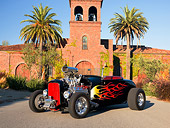 AUT 26 RK1199 01
1929 Ford Roadster Hot Rod Black With Flames Front 3/4 View On Pavement By Building Palm Trees