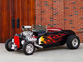 AUT 26 RK1202 01
1929 Ford Roadster Hot Rod Black With Flames Front 3/4 View On Pavement By Building Door