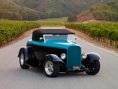 AUT 26 RK1206 01
1932 Ford Roadster Hot Rod Black And Turquoise Front 3/4 View On Pavement By Vineyard Hills Trees