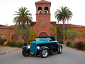 AUT 26 RK1207 01
1932 Ford Roadster Hot Rod Black And Turquoise Front 3/4 View On Pavement By Building Palm Trees Sky