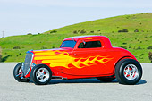 AUT 26 RK1223 01
1934 Ford 3-Window Coupe With Flames 3/4 Front View On Pavement By Grass Hill