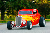 AUT 26 RK1227 01
1934 Ford 3-Window Coupe With Flames 3/4 Front View On Pavement By Trees