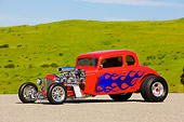 AUT 26 RK1246 01
1934 Chevrolet 5-Window Coupe Hot Rod Red With Blue Flames 3/4 Front View By Grass Hill Blue Sky