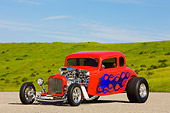 AUT 26 RK1248 01
1934 Chevrolet 5-Window Coupe Hot Rod Red With Blue Flames 3/4 Front View By Grass Hill Blue Sky