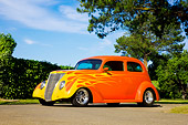 AUT 26 RK1295 01
1937 Ford Sedan Hot Rod Orange 3/4 Front View By Trees Blue Sky