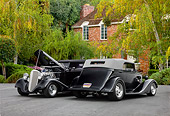 AUT 26 RK1300 01
Two 1934 Chevrolet Phaeton Hot Rods Black 3/4 Front & Rear Views By Trees Shrubs