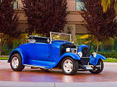 AUT 26 RK2661 01
1929 Ford Model A Roadster Hot Rod Blue 3/4 Front View On Pavement By Shrubs And Trees