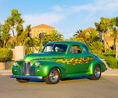 AUT 26 RK2665 01
1940 Chevrolet Coupe Hot Rod Green With Yellow Flames 3/4 Front View On Pavement By Palm Trees