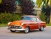 AUT 26 RK2671 01
1953 Chevrolet 210 Coupe Hot Rod Orange With Flames 3/4 Front View On Pavement By Shrubs And Trees