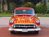 AUT 26 RK2672 01
1953 Chevrolet 210 Coupe Hot Rod Orange With Flames Front View On Pavement By Shrubs And Trees