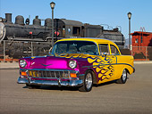 AUT 26 RK2682 01
1956 Chevrolet 210 Post Hot Rod Yellow Purple Flames 3/4 Front View On Pavement By Train
