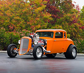 AUT 26 RK2685 01
1934 Plymouth 5-Window Coupe Hot Rod Orange 3/4 Front View On Pavement By Trees